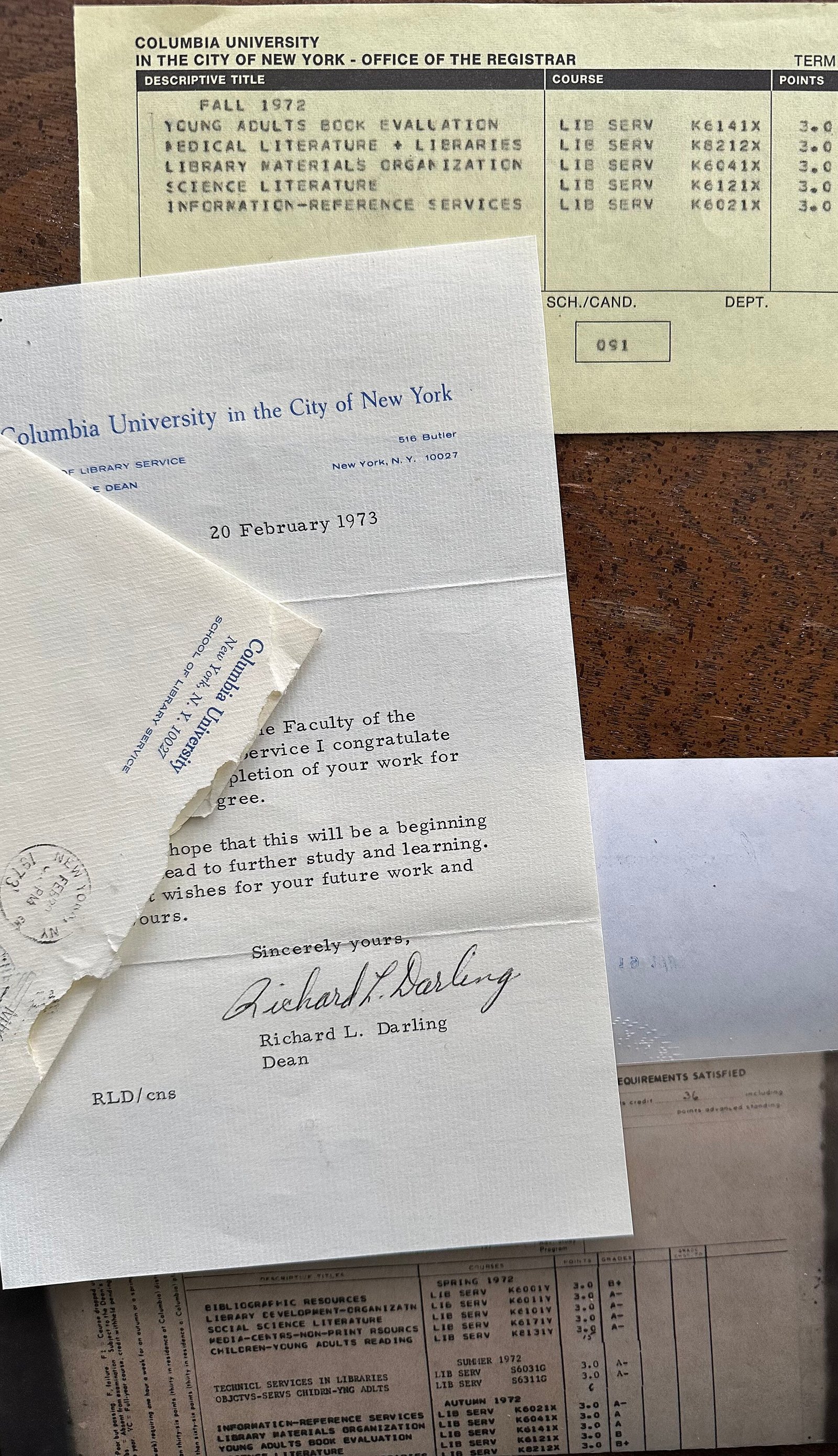 Vintage student record documents laid out on a desk