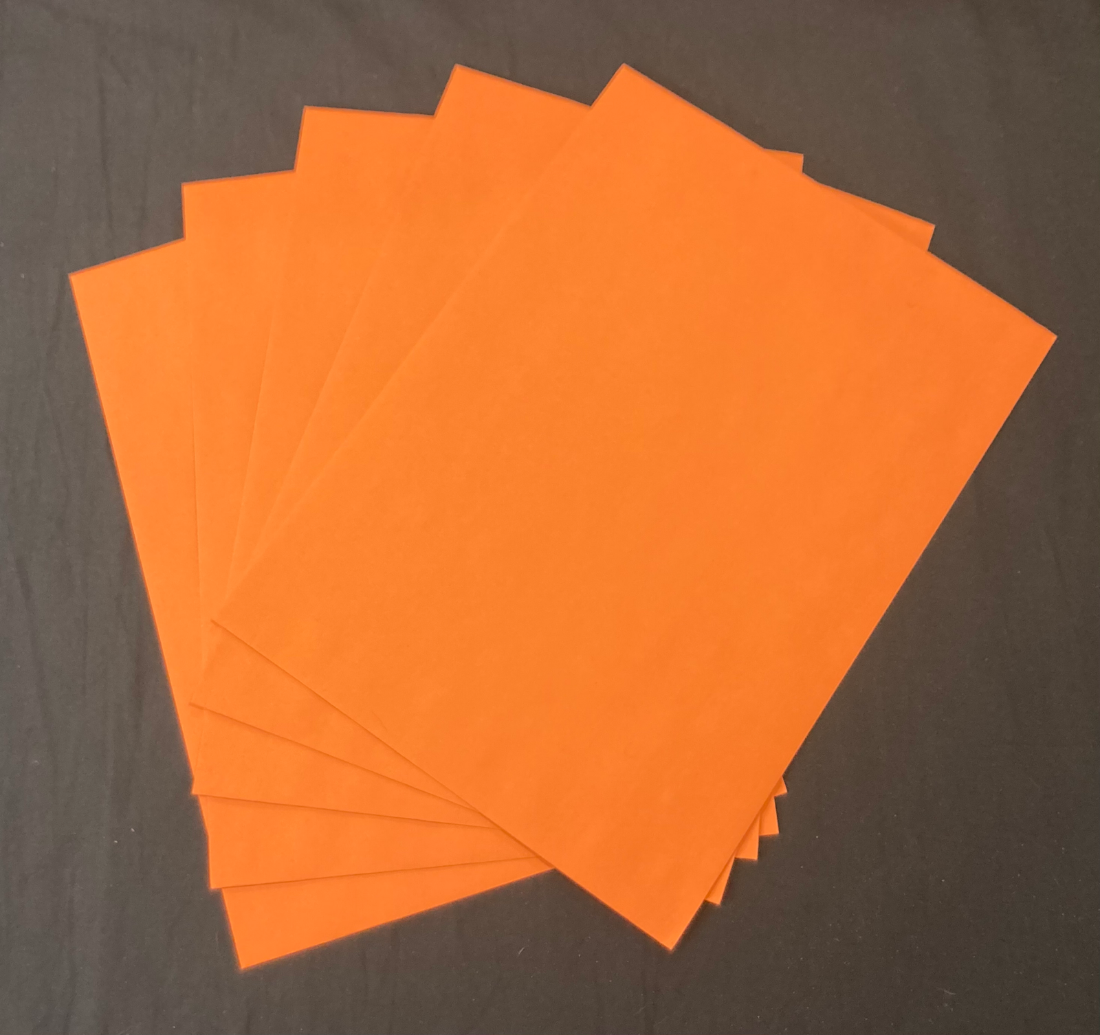 A stack of orange manila envelopes